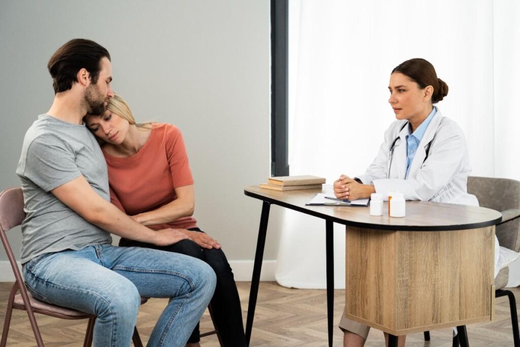 Couple consulting with infertility doctor about conception challenges